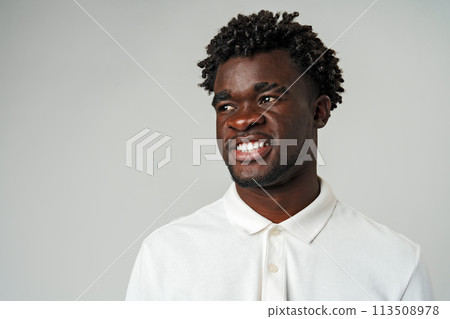 Young African Man Standing in White Shirt on Gray Background. Young African Man Standing in White Shirt on Gray Background. 113508978