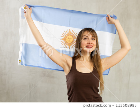 Portrait of happy woman of Argentina match waving national flag 113508983