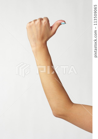 Female hand showing thumbs up sign against white background Female hand showing thumbs up sign against white background 113509065