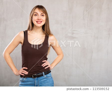 Young cheerful woman with wide grin on her face exuding happiness and positivity Young cheerful woman with wide grin on her face exuding happiness and positivity 113509152