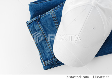 Pair of Jeans and Baseball Cap on White Background Pair of Jeans and Baseball Cap on White Background 113509366
