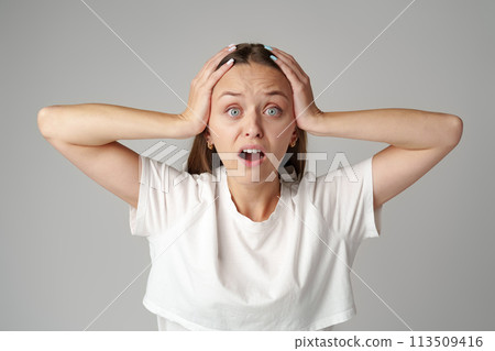 Portrait of beautiful stressed troubled woman on gray background 113509416