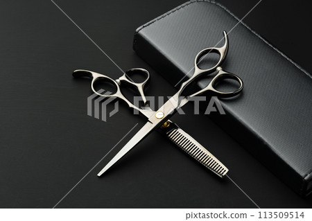Hairdressing scissors with case on a black background 113509514