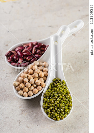 mix of beans on wooden table 113509555