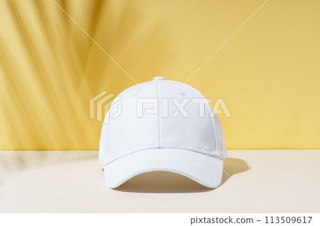 White Baseball Cap on Table White Baseball Cap on Table 113509617