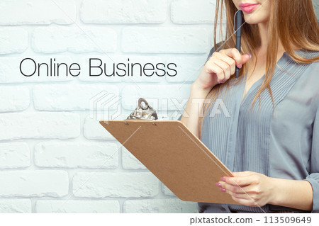businesswoman with clipboard and pen making notes and standing near text businesswoman with clipboard and pen making notes and standing near text 113509649