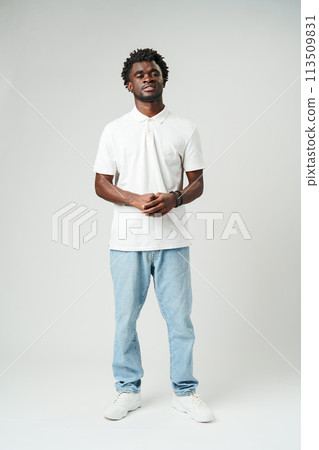 Man Standing in White Shirt and Jeans 113509831