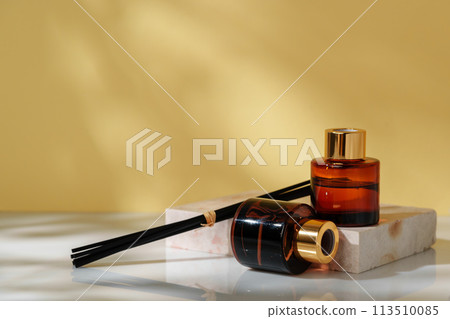 Luxury Perfume Bottles Elegantly Displayed on Marble Slab Against Golden Background 113510085