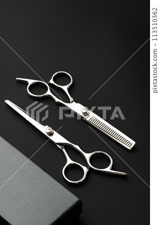 Hairdressing scissors with case on a black background Hairdressing scissors with case on a black background 113510362