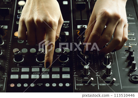 DJ playing music at mixer closeup DJ playing music at mixer closeup 113510446