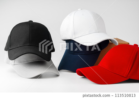 Stack of Assorted Baseball Caps on a White Background Stack of Assorted Baseball Caps on a White Background 113510813