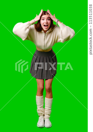 Young Woman Gesturing Excitement in Casual Attire Against Green Screen Backdrop Young Woman Gesturing Excitement in Casual Attire Against Green Screen Backdrop 113511038
