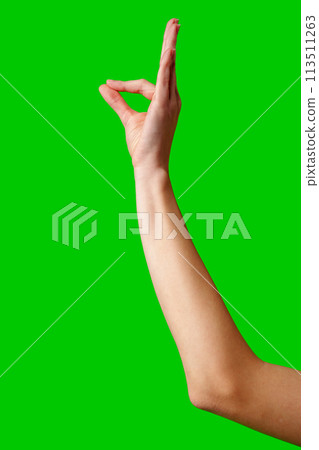 Hand Gesturing Okay Sign Against a Vibrant Green Background 113511263
