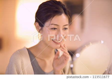 Middle-aged woman doing night skin care 113511677