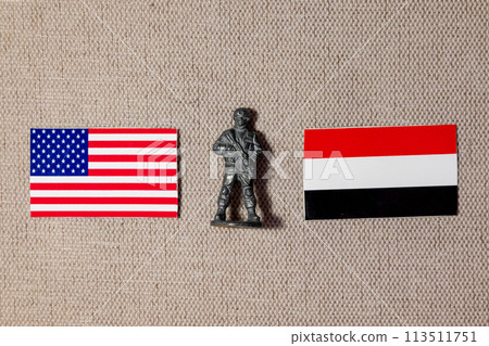 A soldier figurine on the background of the flags of the United States and Yemen 113511751