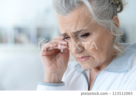 Close up portrait of a sick senior woman 113512065