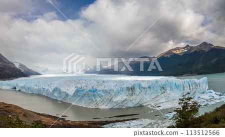 Majestic Glacier View Amidst Mountains and Cloudy Sky 113512566