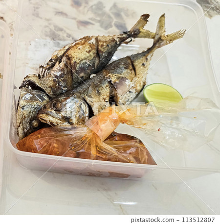 Fried Mackerel served with separate chili sauce and lime, or called Ikan kembung goreng. ikan banyar goreng  113512807