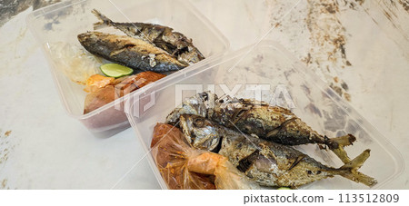 Fried Mackerel served with separate chili sauce and lime, or called Ikan kembung goreng. ikan banyar goreng with rica sambal 113512809