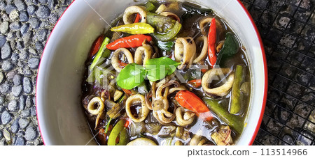 ndonesian home cooking menu, sauteed squid with black ink sauce with spicy seasoning called Tumis Cumi Hitam, including chili, ginger, and lime leaf ndonesian home cooking menu, sauteed squid with black ink sauce with spicy seasoning called Tumis Cumi Hitam, including chili, ginger, and lime leaf 113514966