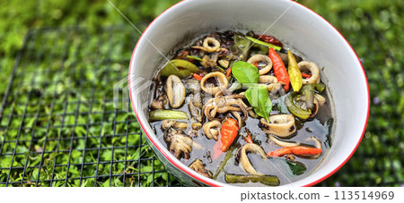 ndonesian home cooking menu, sauteed squid with black ink sauce with spicy seasoning called Tumis Cumi Hitam, including chili, ginger, and lime leaf ndonesian home cooking menu, sauteed squid with black ink sauce with spicy seasoning called Tumis Cumi Hitam, including chili, ginger, and lime leaf 113514969