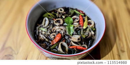 ndonesian home cooking menu, sauteed squid with black ink sauce with spicy seasoning called Tumis Cumi Hitam, including chili, ginger, and lime leaf 113514980