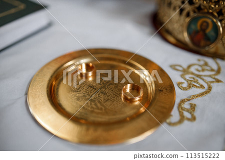 wedding rings on a gold plate 113515222