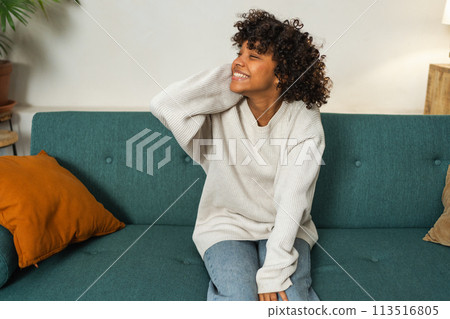 Beautiful African American girl with afro hairstyle smiling. Close up portrait of young happy black girl. Young African woman with curly hair laughing. Freedom happiness carefree happy people concept 113516805