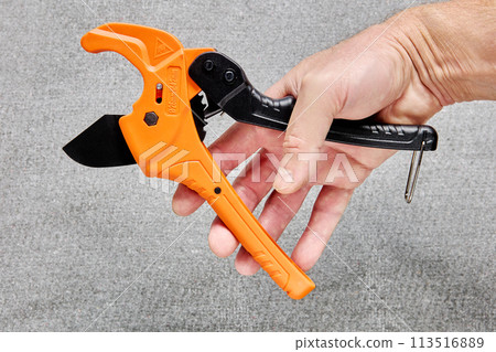 Ratchet type pipe cutter, one hand fast pipes cutting tool on gray background. Ratchet type pipe cutter, one hand fast pipes cutting tool on gray background. 113516889