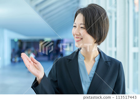 A woman in a suit posing as a guide 113517443