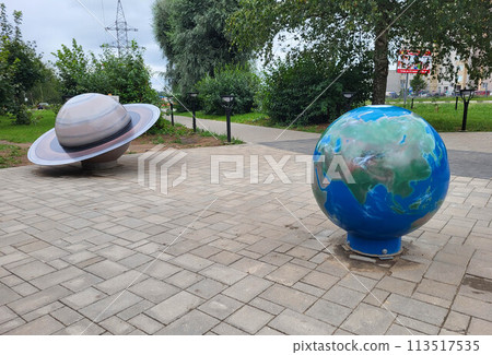TUTAEV, Russia - March 3, 2024: an open-air installation in the form of a planet in a children's park. The concept of Earth Day and Cosmonautics Day. TUTAEV, Russia - March 3, 2024: an open-air installation in the form of a planet in a children's park. The concept of Earth Day and Cosmonautics Day. 113517535