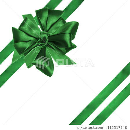 Tied bow made of green silk ribbon on an isolated background, decor for a gift. Tied bow made of green silk ribbon on an isolated background, decor for a gift. 113517548