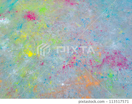 After the celebration of Holi, scattered paints on the asphalt 113517571