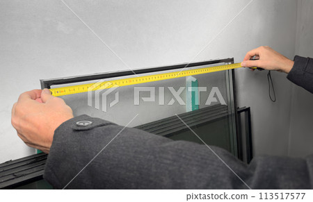 Hands with tape, measuring tool for construction industry 113517577