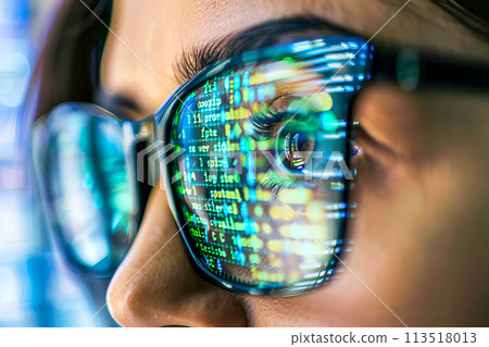 Detailed view of a persons face with glasses and focused eyes into a computer monitor. Detailed view of a persons face with glasses and focused eyes into a computer monitor. 113518013