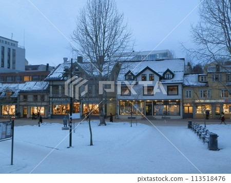 Lit storefronts in the morning 113518476