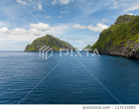 Blue sea and Islands under blue sky and clouds in El Nido. Tapiutan and Matinloc. Philippines. Blue sea and Islands under blue sky and clouds in El Nido. Tapiutan and Matinloc. Philippines. 113518865