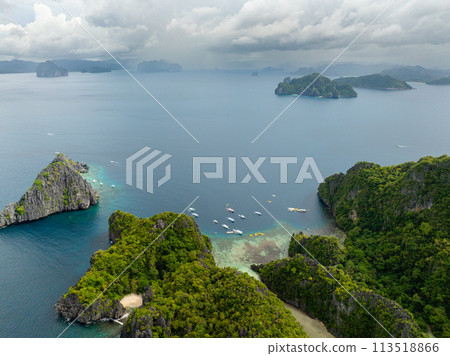 Boats and Kayaks over the blue sea. Miniloc and Twin Rocks in El Nido, Palawan. Philippines. 113518866