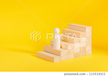 Businessman climbing stairs. Business success process, career ladder. Wooden figurine Businessman climbing stairs. Business success process, career ladder. Wooden figurine 113519321