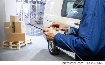 Manager with a digital tablet on the background of van. Fleet and warehouse management.. 113520666
