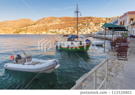 Fishing boats in the village of Symi at sunset. 113520801
