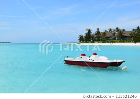 Maldives crystal water and motorboat 113521240