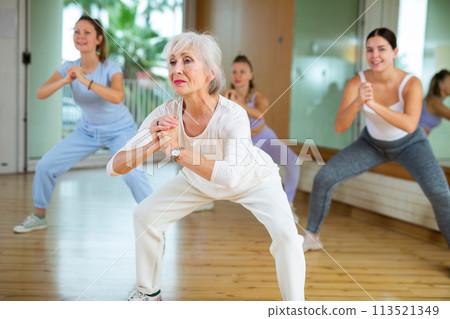 Group are practising arch movement in step jazz dance in fitness gym 113521349