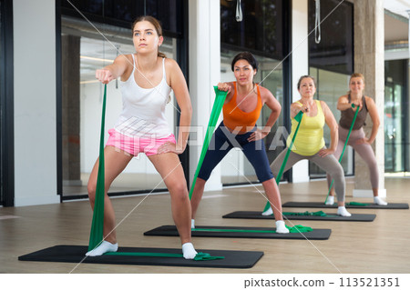 Women doing stretches with resistance bands Women doing stretches with resistance bands 113521351