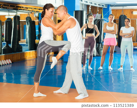 Woman doing knee strike Woman doing knee strike 113521389