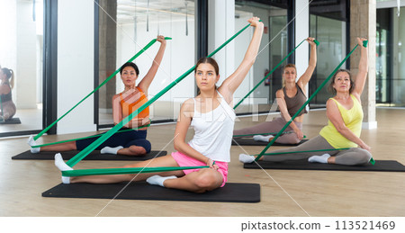 Women doing stretches with resistance bands Women doing stretches with resistance bands 113521469