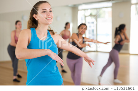 Young adult athletic woman dancing 113521601