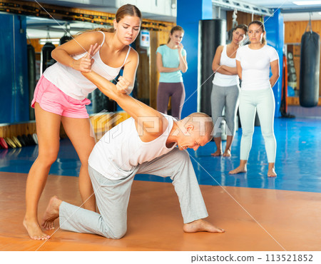 Young lady doing armlock movement Young lady doing armlock movement 113521852
