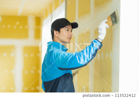 A young man working in the interior design industry A young man working in the interior design industry 113522412