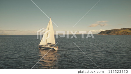 Ocean bay cruise on yacht aerial. Summer tour on sail boats at Brodick pier, Arran island, Scotland Ocean bay cruise on yacht aerial. Summer tour on sail boats at Brodick pier, Arran island, Scotland 113523550